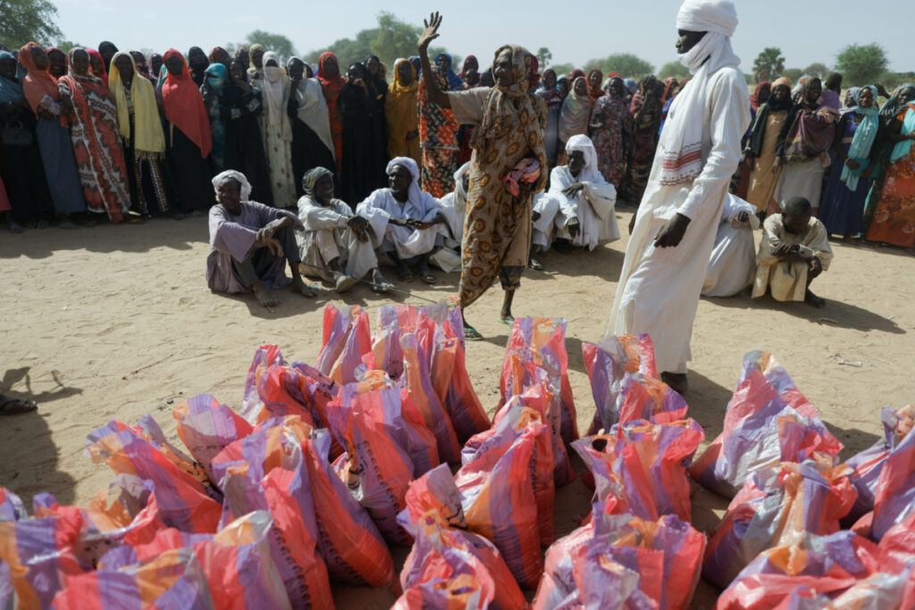 Sudanese refugees, who fled the violence in their country, wait to receive food supplies from a Turkish aid group near the border between Sudan and Chad in Koufroun, Chad, on 7th May 2023