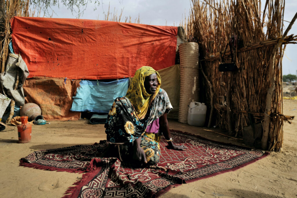 Halime Adam Moussa, a Sudanese refugee who is seeking refuge in Chad for a second time, sits beside her shelter, near the border between Sudan and Chad in Koufroun, Chad, on 10th May, 2023