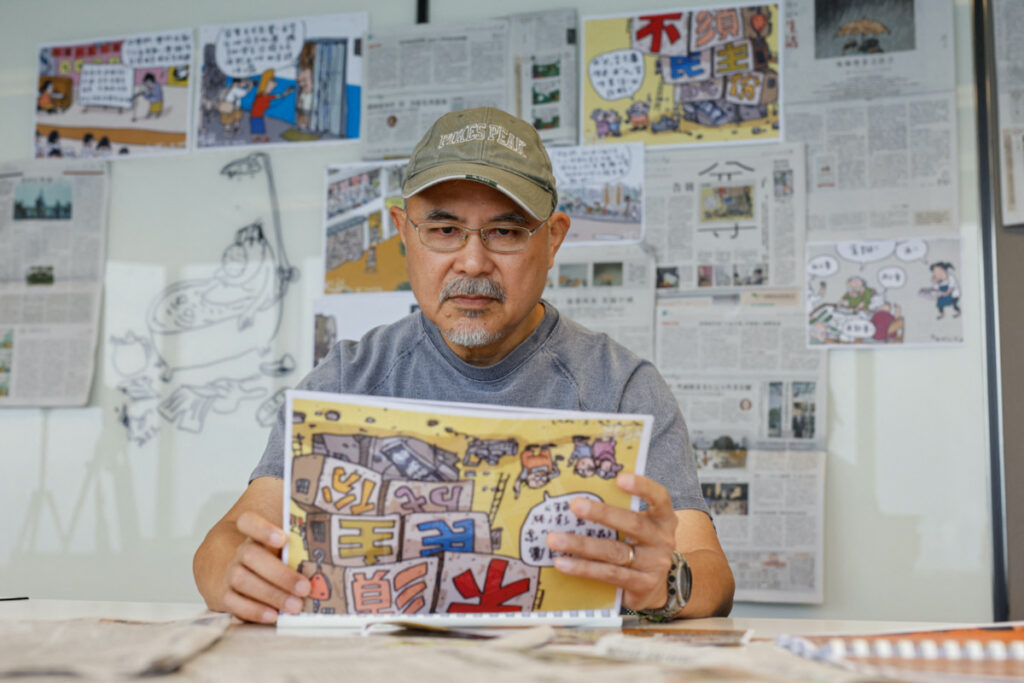 Cartoonist Wong Kei-kwan, who uses the pen name Zunzi, poses for photos after his comic strip has been scrapped from the local newspaper Ming Pao in Hong Kong, China, on 15th May, 2023.