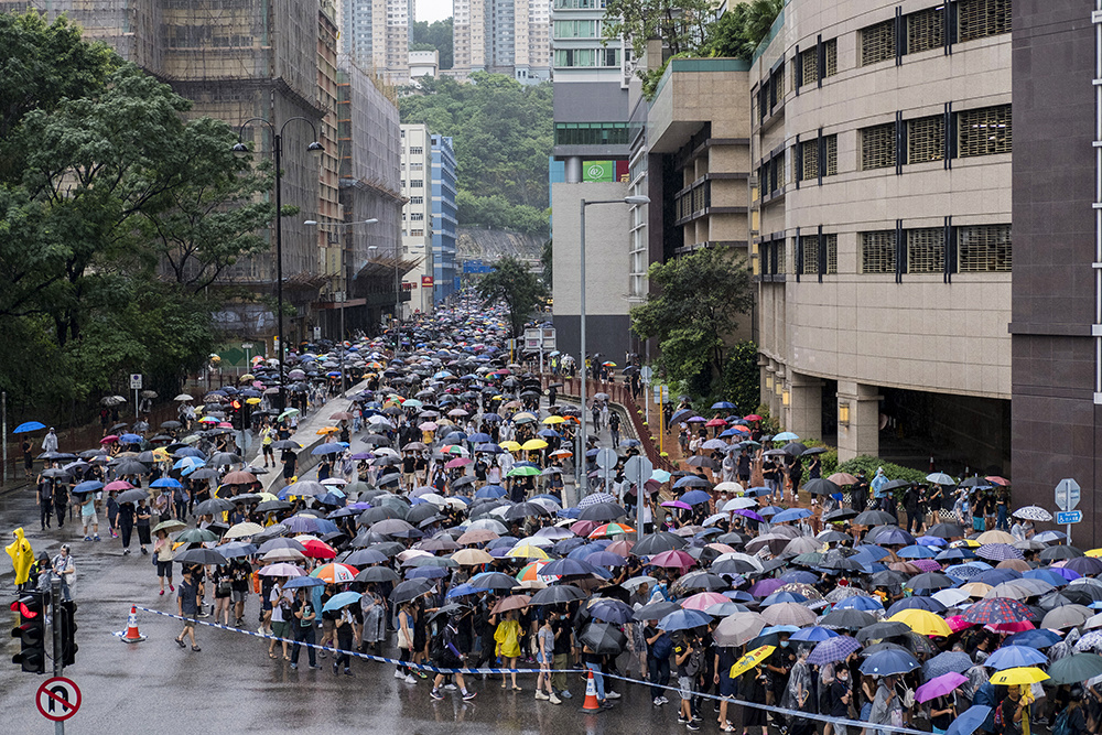 Tens of thousands of people march through rain in Hong Kong on 25th August, 2019.