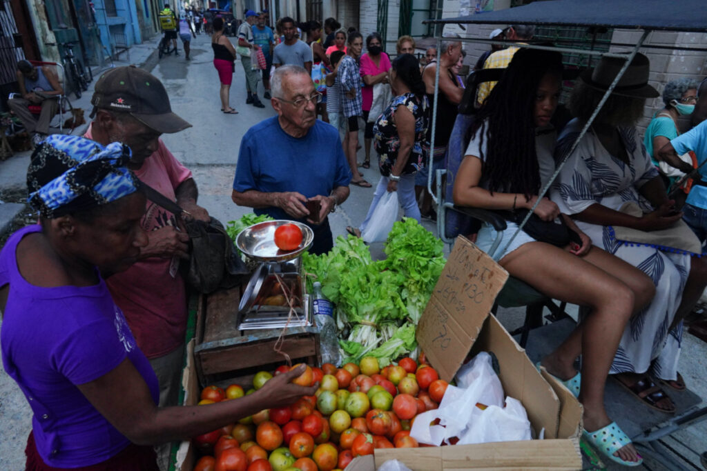 People buy vegetables on the street in downtown Havana, Cuba, November 30, 2022.