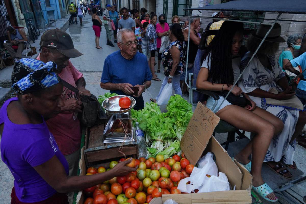 People buy vegetables on the street in downtown Havana, Cuba, November 30, 2022.