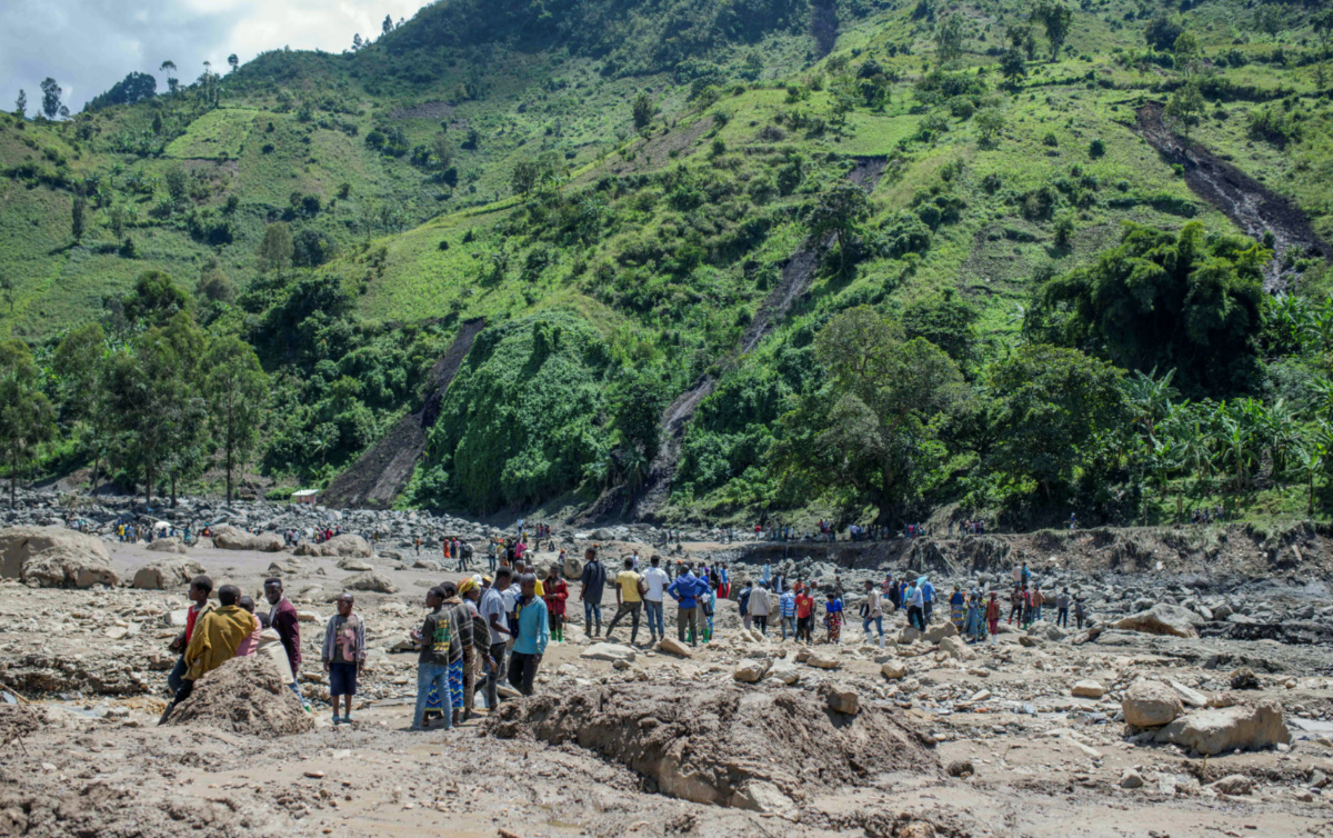 Congolese civilians gather after the death of their family members following rains that destroyed buildings and forced aid workers to gather mud-clad corpses into piles, in the village of Nyamukubi, Kalehe territory in South Kivu province of the Democratic Republic of Congo, on 6th May, 2023.