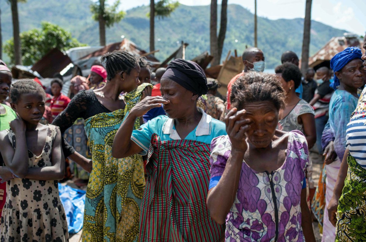 Congolese women react after the death of their family members following rains that destroyed buildings and forced aid workers to gather mud-clad corpses into piles in the village of Nyamukubi, Kalehe territory in South Kivu province of the Democratic Republic of Congo, on 6th May, 2023