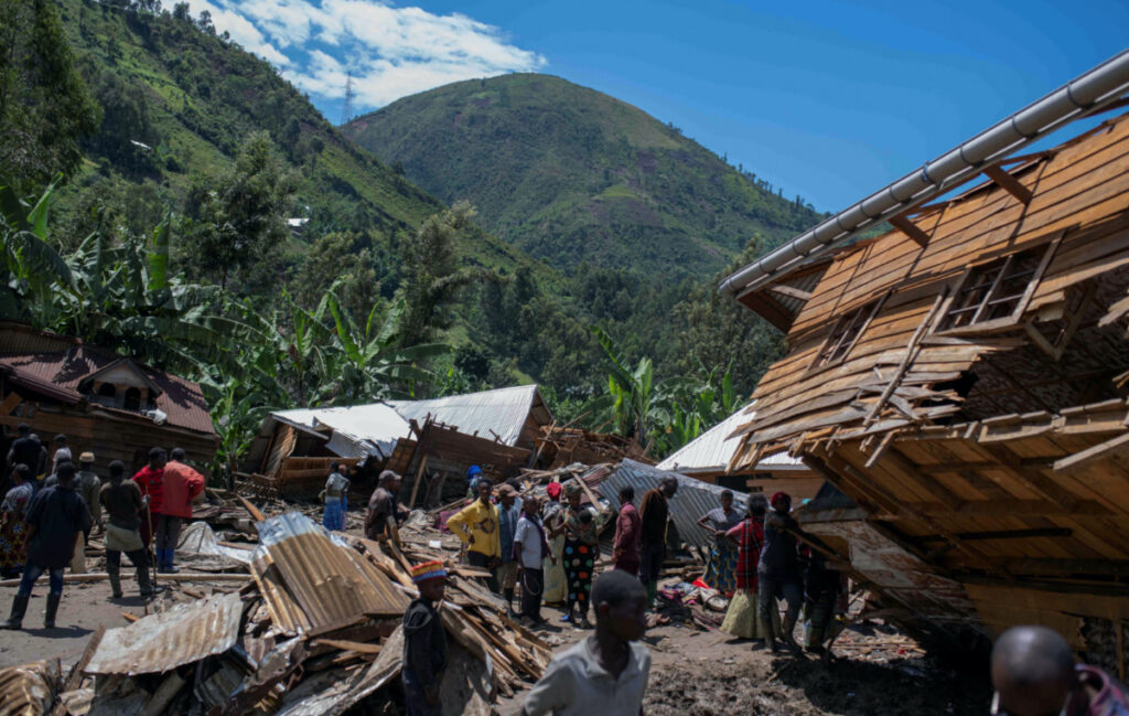 Congolese civilians gather after the death of their family members following rains that destroyed buildings and forced aid workers to gather mud-clad corpses into piles in the village of Nyamukubi, Kalehe territory in South Kivu province of the Democratic Republic of Congo, on 6th May 2023.