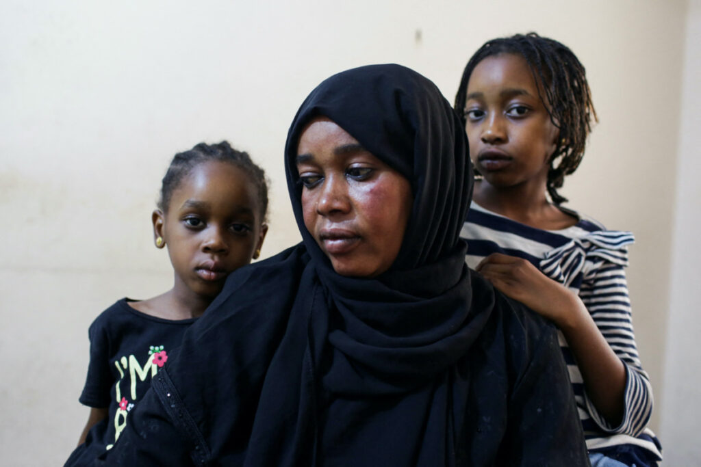 Sanaa Mahmoud, a Sudanese displaced woman, and her daughters Talia and Talien, who fled after the last crisis in Sudan's capital Khartoum, look on during an interview with Reuters as they stay at a shelter in the district of Boulaq Al-Dakrour in Giza, Egypt, on 13th May, 2023.