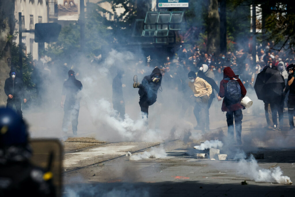 Demonstrators throw tear gas as they clash with police during the traditional May Day labour march, a day of mobilisation against the French pension reform law and for social justice, in Nantes, France, on 1st May, 2023