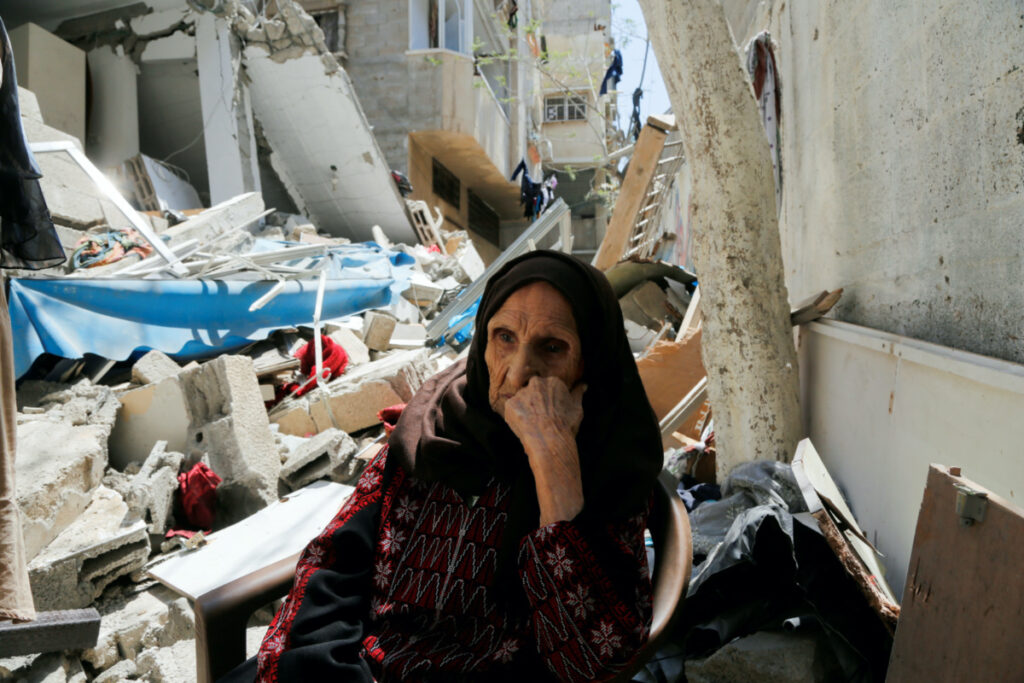 Palestinian woman Intisar Muhana, 97, who was forced to flee al-Masmiyya village during the 'Nakba', or catastrophe in the war surrounding Israel's independence in 1948 and whose house was destroyed in an Israeli strike in the recent Israel-Gaza fighting, sits in front of the rubble of her house, in Gaza City, on 14th May, 2023.