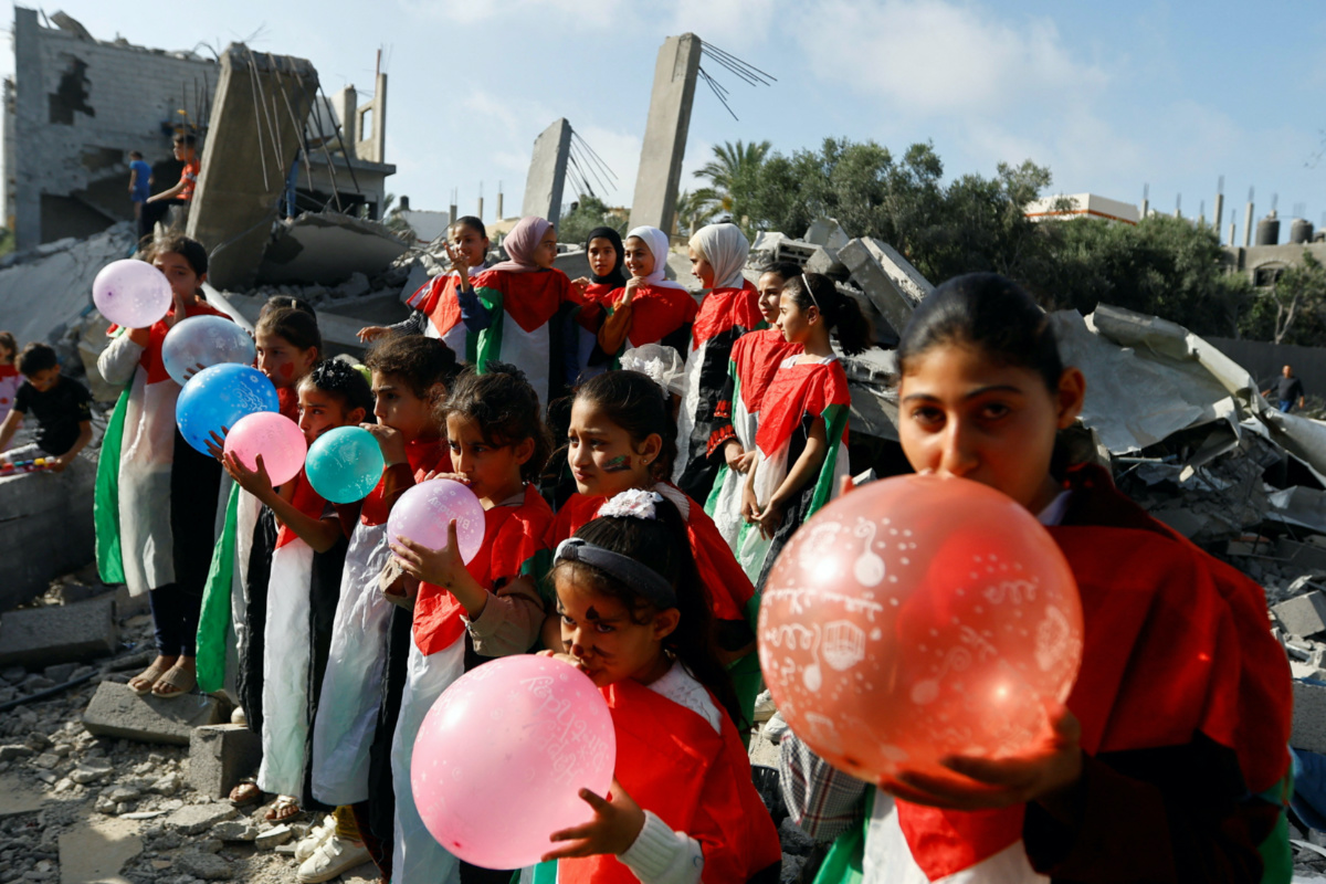 Palestinian children participate in an activity, aimed to support their mental health, near the site of an Israeli strike, in Deir al-Balah, central Gaza Strip, on 15th May, 2023. 