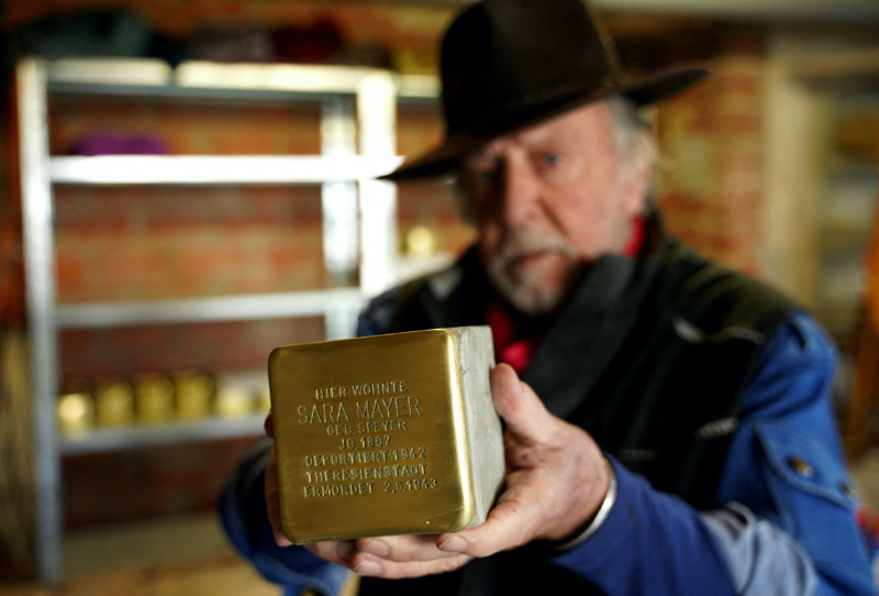 Gunter Demnig holds a Stumbling stone at his workshop in Alsfeld, Germany, on 28th February, 2023.