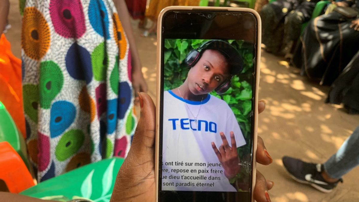 A relative shows a portrait of Boubacar Diallo, 17, who was killed during the May clashes between demonstrators and security forces, on his phone during a ceremony in support of his family in Conakry, Guinea, on 11th May, 2023.