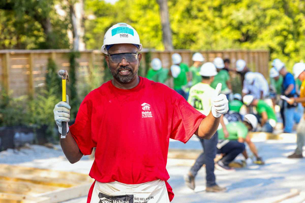 Mustafa, a future Habitat for Humanity homeowner, poses while working on a project in the Nasvhille area in August 2022. 