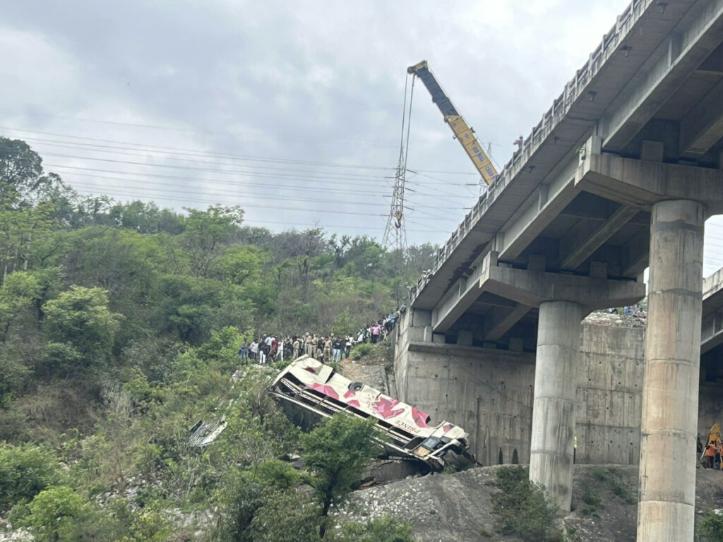 Rescuers prepare to use a crane after a bus carrying Hindu pilgrims to a shrine skid off a highway bridge into a Himalayan gorge near Jammu, India, on Tuesday, 30th May, 2023.
