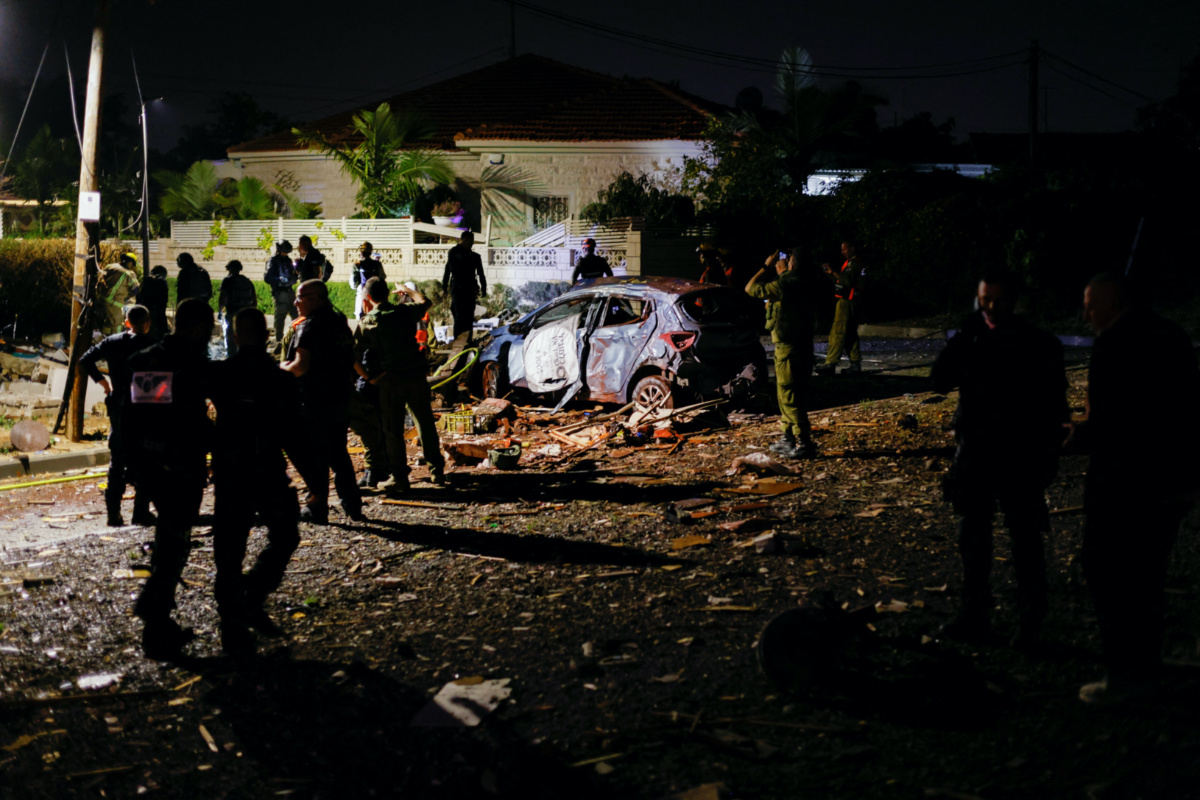 Security and rescue personnel work at the site where a rocket fired from Gaza has landed in Ashkelon, Israel, on 10th May, 2023 