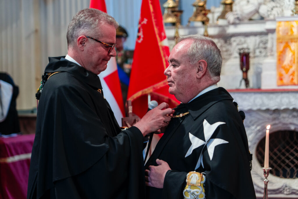 John Dunlap, right, receives the grand master's collar from the Grand Commander of the Sovereign Military Order of Malta, Emmanuel Rousseau after swearing in as 81st grand master of the order in Rome, Wednesday, on 3rd May 3, 2023.