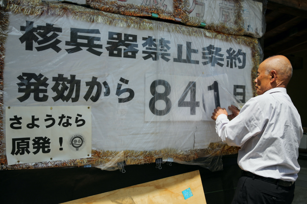 Atomic bomb survivor Toshiyuki Mimaki changes the numbers on a poster counting the days since the Nuclear Weapon Ban Treaty came into effect at his home in Yamagata district, Hiroshima prefecture, western Japan, on 12th May, 2023