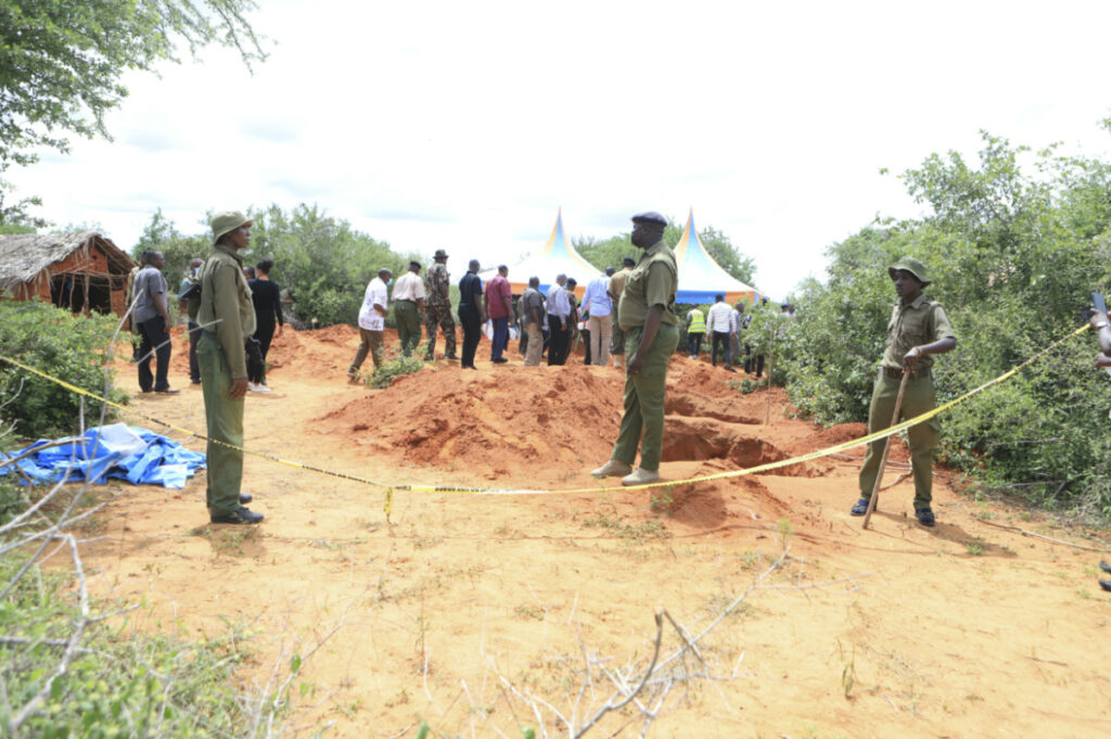 Police officers stand near a cordon at the scene where police are exhuming bodies of victims of Christian cult that has led to death of dozens of followers, at a forest in Shakahola area, outskirts of Malindi town, Kenyan Coast Tuesday, on 25th April, 2023.