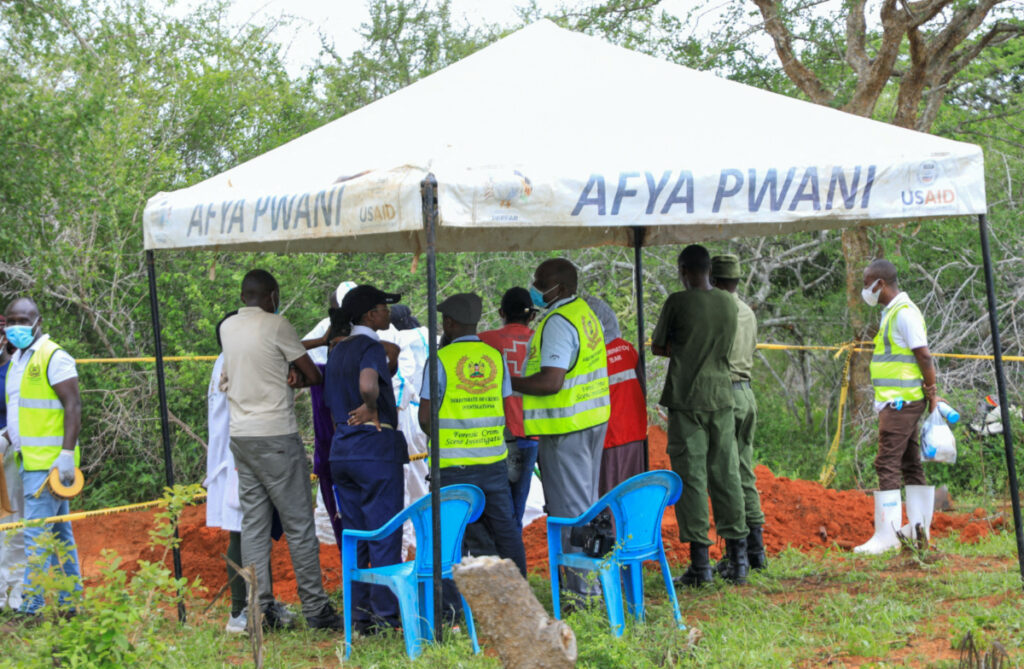 Forensic experts and homicide detectives from the Directorate of Criminal Investigations, gather to exhume bodies of suspected followers of a Christian cult named as "Good News International Church", who believed they would go to heaven if they starved themselves to death, in Shakahola forest of Kilifi county, Kenya, on 9th May, 2023.