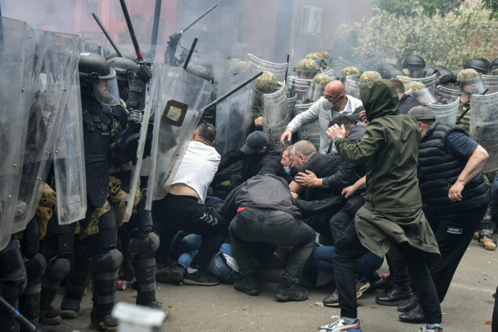 NATO Kosovo Force soldiers clash with local Kosovo Serb protesters at the entrance of the municipality office, in the town of Zvecan, Kosovo, on 29th May, 2023.