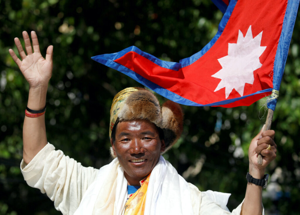 Nepali mountaineer Kami Rita Sherpa waves upon his arrival after climbing Mount Everest for the 24th time in 2019, setting a record for the most summits of the world's highest mountain, in Kathmandu, Nepal, on 25th May, 2019.