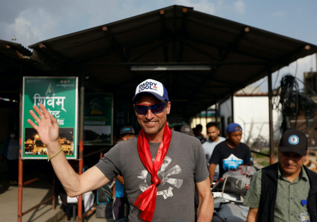 British climber Kenton Cool, 49, waves towards the media personnel, upon his arrival at the airport, as he returns after completing his 17th ascent of Mount Everest, which is the most by any foreign climber, in Kathmandu, Nepal, on 19th May, 2023.