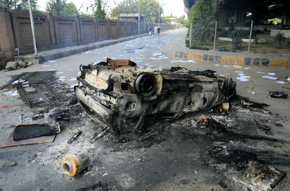 Debris of a vehicle is seen after it was set afire by the supporters of Pakistan's former Prime Minister Imran Khan during a protest against his arrest, in Peshawar, Pakistan, on 10th May, 2023