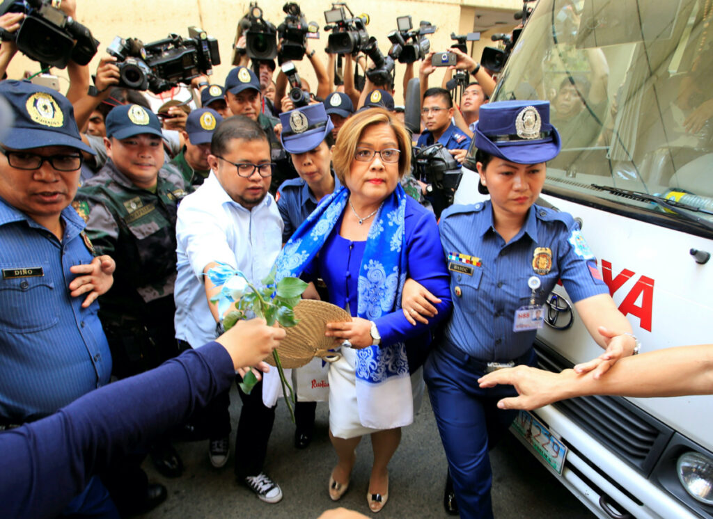 Philippine police escort Leila de Lima, a senator detained on drug charges, on her way to a local court to face an obstruction of justice complaint in Quezon city, metro Manila, Philippines on 13th March 2017.