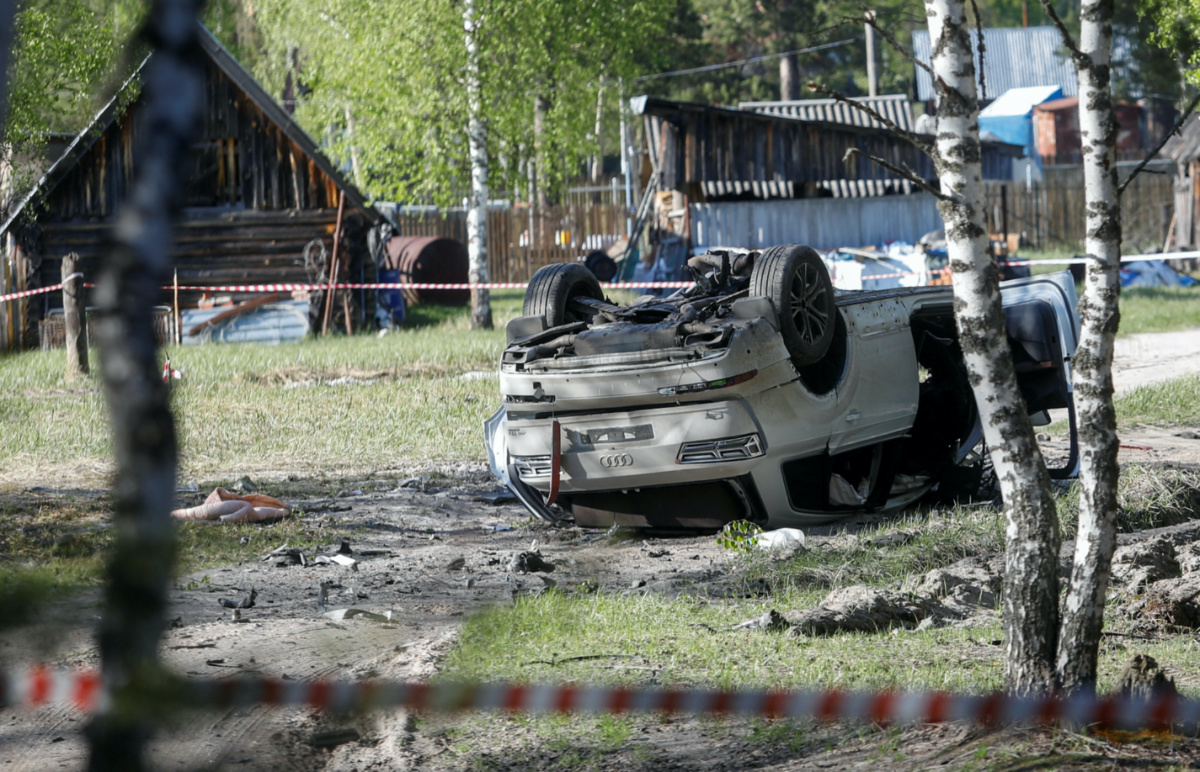 A view shows a damaged white Audi Q7 car lying overturned on a track next to a wood, after Russian nationalist writer Zakhar Prilepin was allegedly wounded in a bomb attack in a village in the Nizhny Novgorod region, Russia, on 6th May, 2023