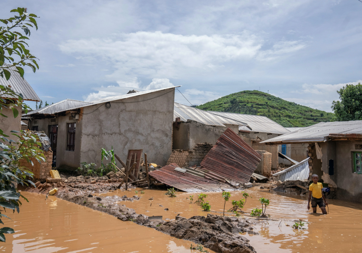 A boy wades through waters after their home was swamped, following rains that triggered flooding and landslides in Rubavu district, Western province, Rwanda, on 3rd May, 2023.
