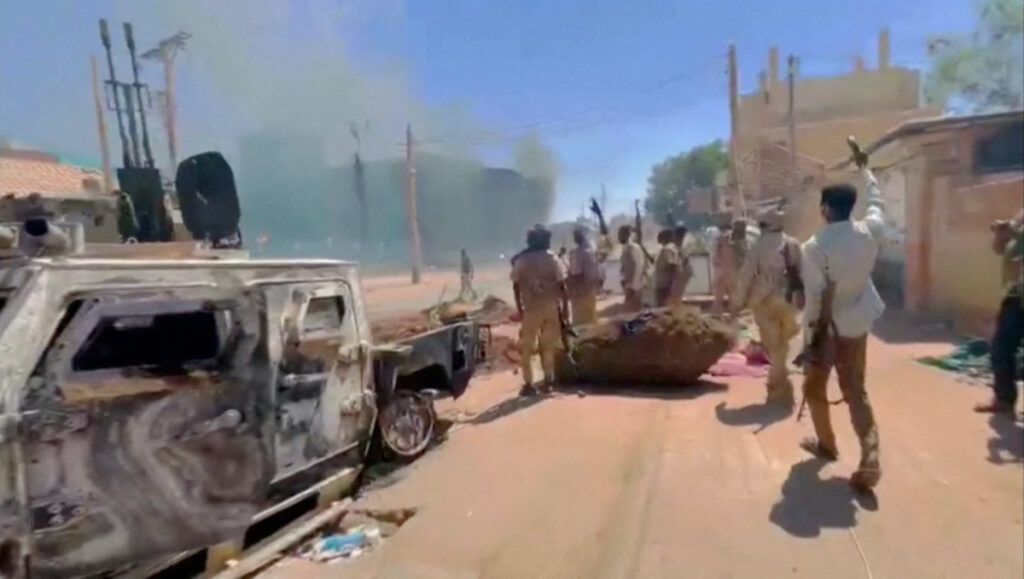 RSF fighters stand near the damaged Air Defence Forces command centre in Khartoum, Sudan, on 17th May, 2023, in this screen grab obtained from a social media video.