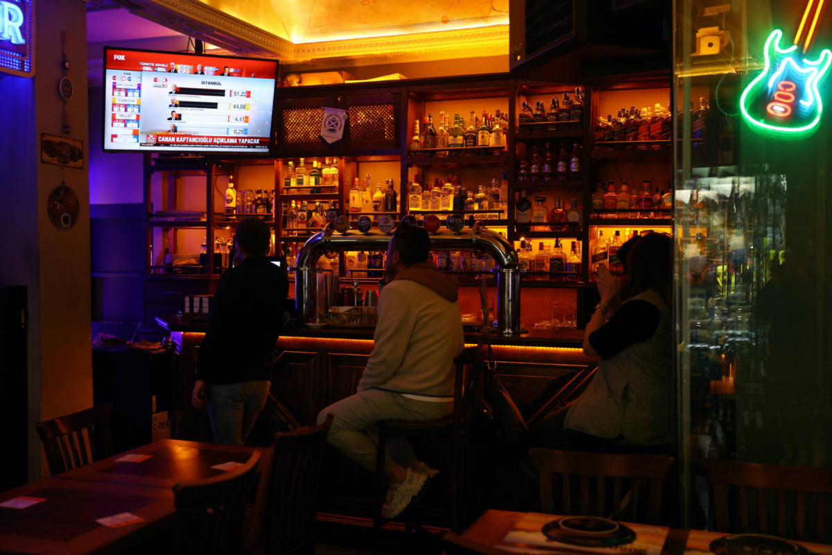 People watch the Turkish presidential and parliamentary elections on a TV screen at a bar in Istanbul, Turkey, on 14th May, 2023