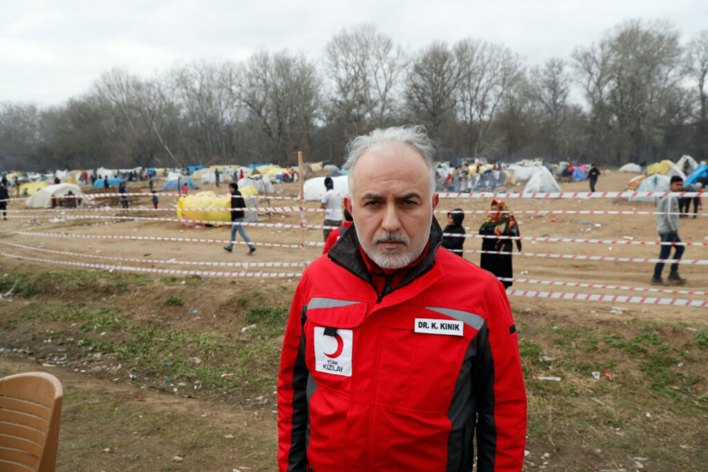 Turkish Red Crescent President Kerem Kinik, with makeshift shelters for migrants in the background, is seen at Turkey's Pazarkule border crossing with Greece's Kastanies, near Edirne, Turkey, on 5th March, 2020.