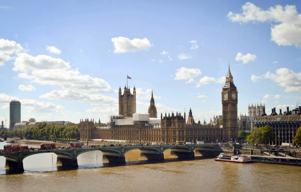 The River Thames runs in front of the Palace of Westminster, which houses Parliament.