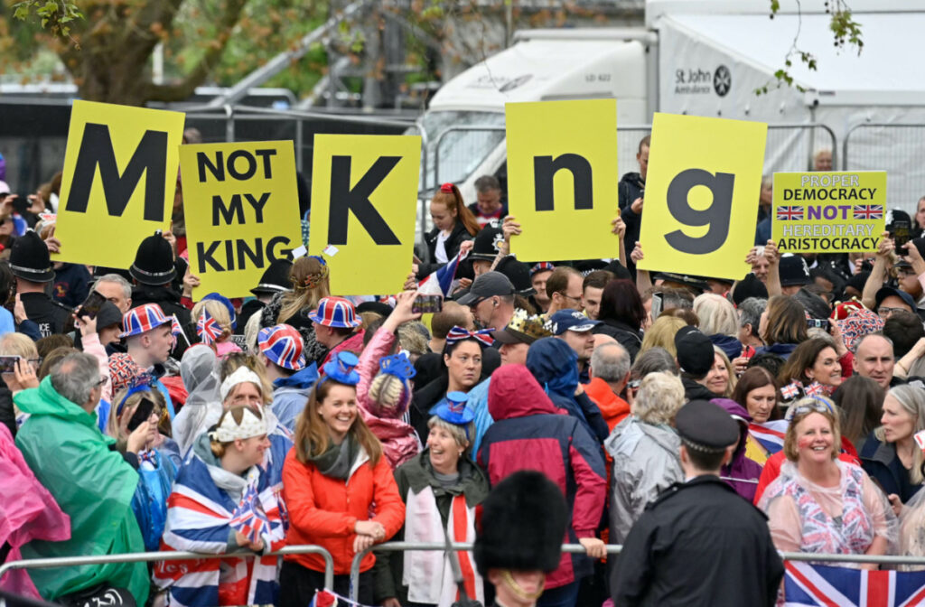 Protesters wave "Not My King" signs near to the 'King's Procession', a journey of two kilometres from Buckingham Palace to Westminster Abbey in central London on 6th May, 2023, ahead of their coronations