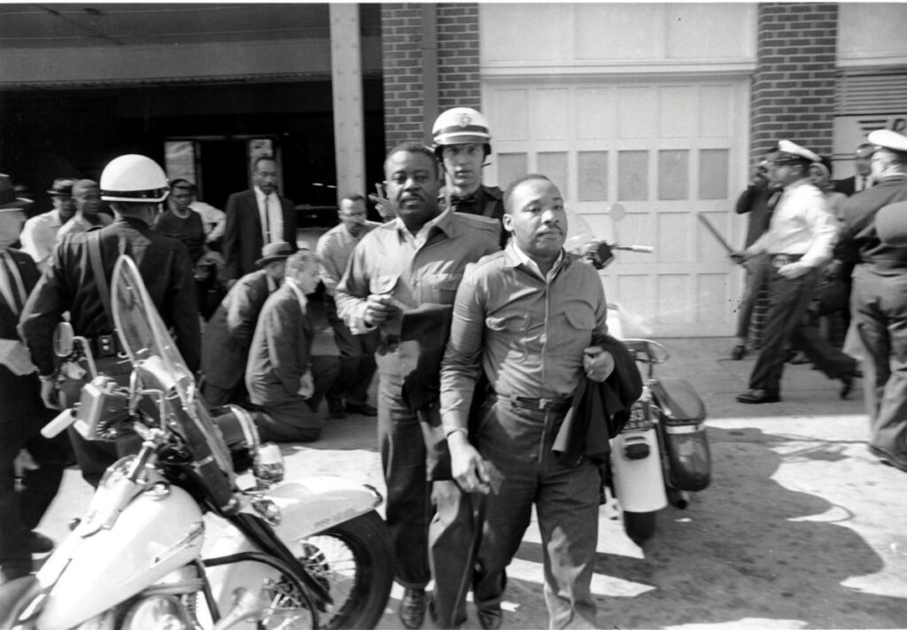 In this file photo taken on 12th April, 1963, Rev Ralph Abernathy, left, and Rev Martin Luther King Jr, right, are taken by a policeman as they led a line of demonstrators into the business section of Birmingham, Alabama.