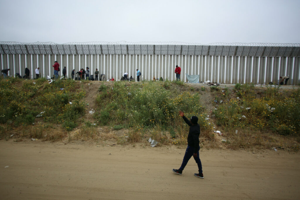 Migrants camp between the two border fences as they wait for authorities to request asylum in San Ysidro, California, US, as seen from Tijuana, Mexico, on 30th April, 2023.