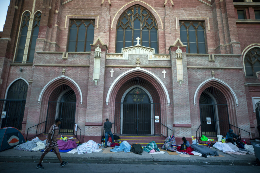 In this photo taken on Tuesday, 9th May, 2023, migrants wake up at the campsite outside Sacred Heart Church in downtown El Paso, Texas.