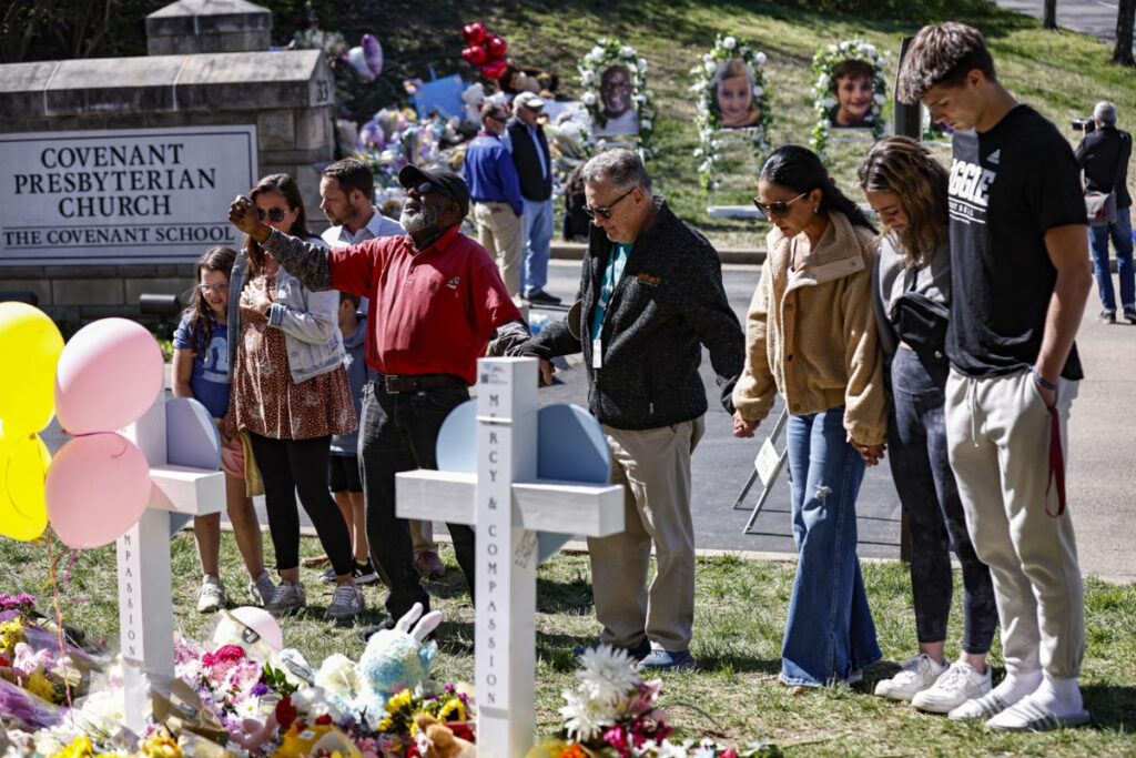 Fitzgerald Moore leads a group in prayer at a memorial at the entrance to The Covenant School on Wednesday, 29th March, 2023, in Nashville, Tennessee, US
