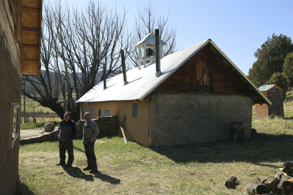 'Hermanos' Fidel Trujillo, left, and Leo Paul Pacheco, look at the kitchen recently built with adobe next to the 1860s 'morada' de San Isidro, which is the main chapel and meeting point of their Catholic brotherhood, outside Holman, New Mexico, on Saturday, 15th April, 2023.