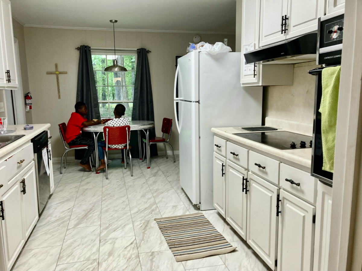 Two boys, part of a refugee family from the Democratic Republic of Congo, share an afternoon snack at a house owned by Temple Baptist Church in Durham, North Carolina.