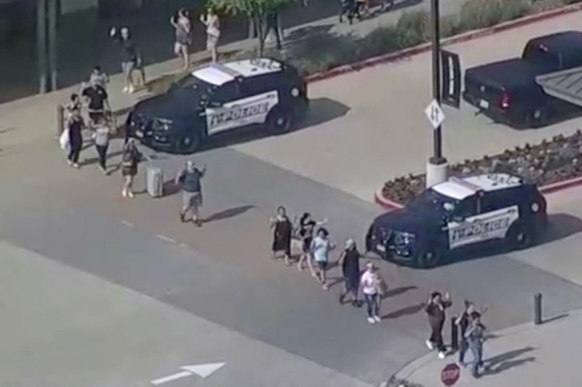 Shoppers leave with hands up as police respond to a shooting in the Dallas area's Allen Premium Outlets, which authorities said has left multiple people injured in Allen, Texas, US, on 6th May, 2023 in a still image from video.