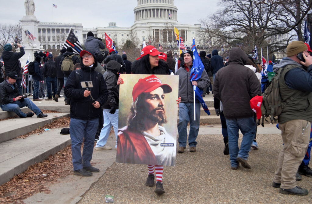 White MAGA QAnon Jesus carried during the 6th January invasion of the Capitol.