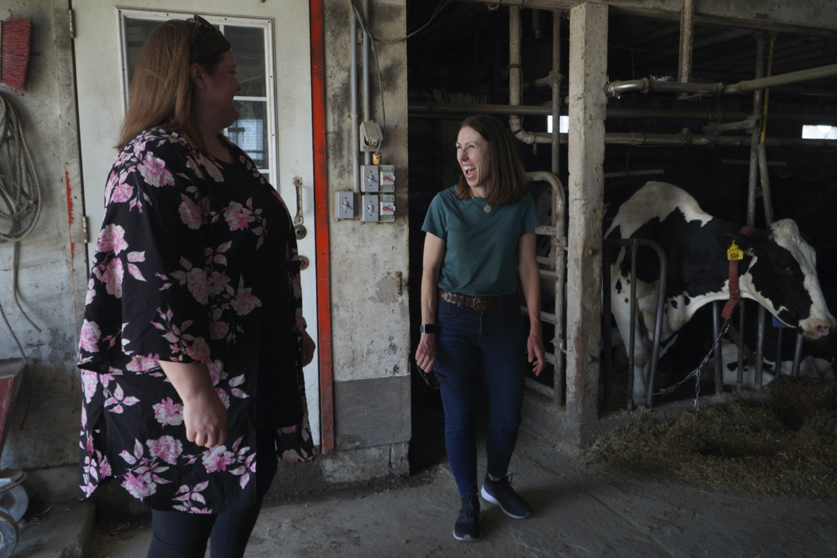 The Rev. Jillene Gallatin, of Grace Lutheran Church, right, visits with congregant Cassie Eldeen, whose family owns a dairy farm in Waseca, Minnesota, on Thursday, 4th May, 2023. 