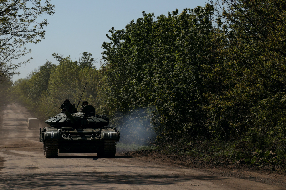 Ukrainian servicemen ride atop of a tank on a road to the frontline town of Bakhmut, amid Russia's attack on Ukraine, in Donetsk region, Ukraine, on 12th May, 2023.