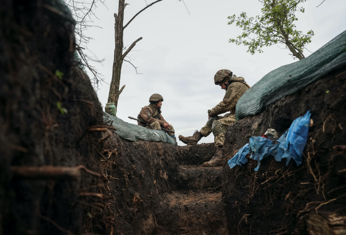 Ukrainian service members rest near a trench at a frontline, amid Russia's attack on Ukraine, in Donetsk region, Ukraine, on 28th April, 2023