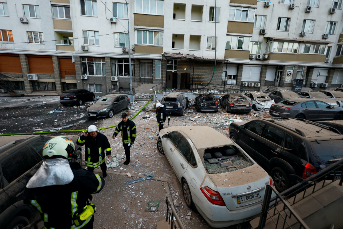 Firefighters work near cars damaged during a massive Russian drone strike, amid Russia’s attack on Ukraine, in Kyiv, Ukraine, on 30th May, 2023.