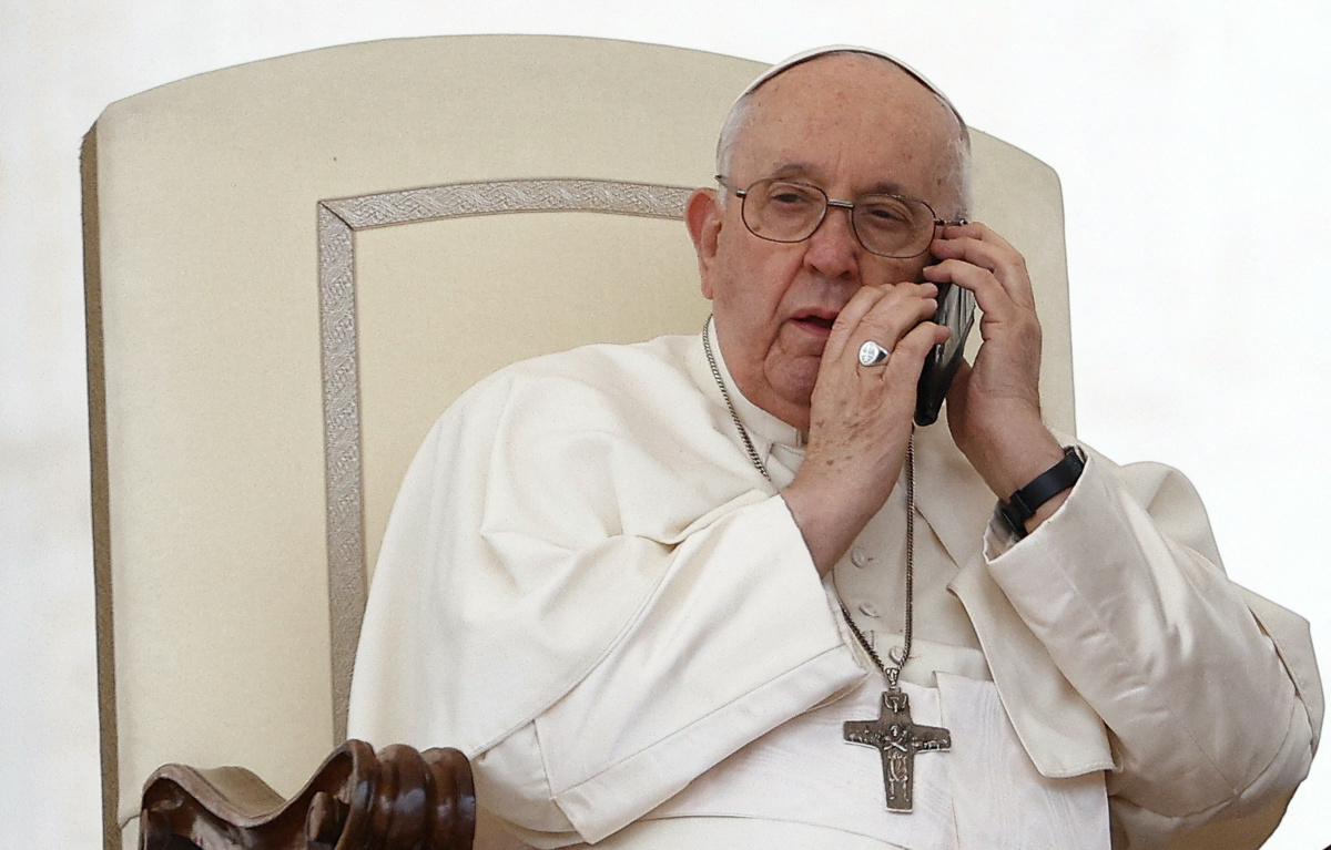 Pope Francis speaks on the phone during the weekly general audience in St. Peter's Square at the Vatican, on 17th May, 2023.