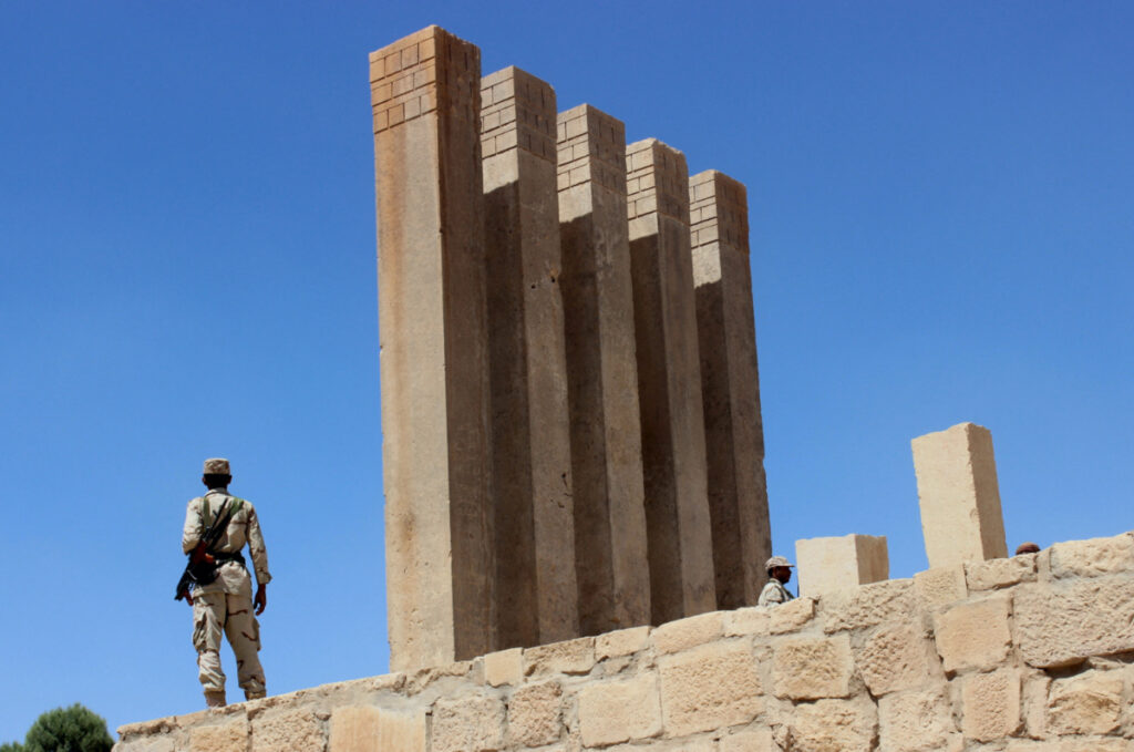 A Yemeni soldier stands next to the 3,000-year old Temple of the Moon in Marib, Yemen, on 16th October, 2015.