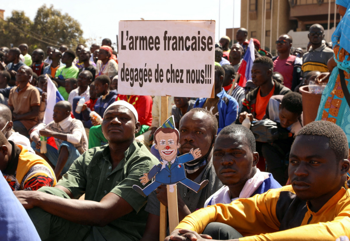 People hold a sign as they gather to show their support to Burkina Faso's new military leader Ibrahim Traore and demand the departure of the French ambassador at the Place de la Nation in Ouagadougou, Burkina Faso, on 20th January, 2023.