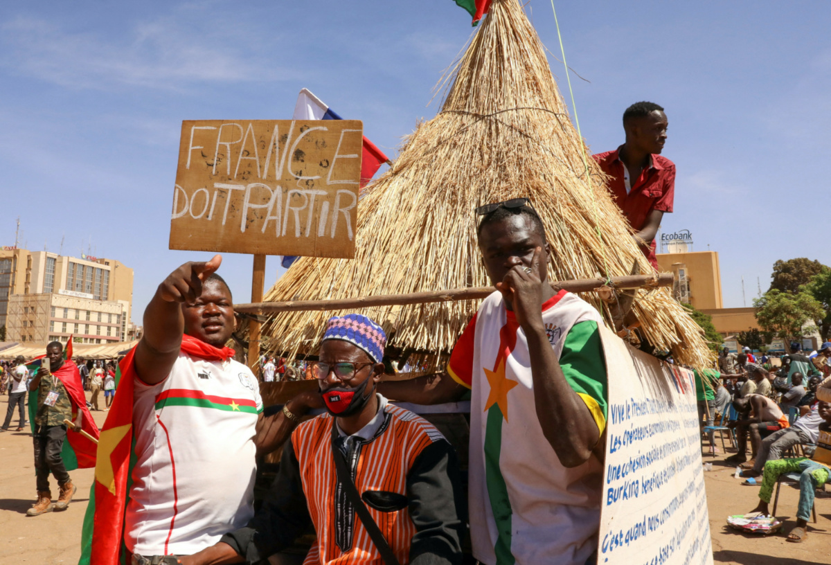People hold a sign to show their support to the Junta leader Ibrahim Traore and demand the departure of the French ambassador at the Place de la Nation in Ouagadougou, Burkina Faso, on 20th January, 2023.